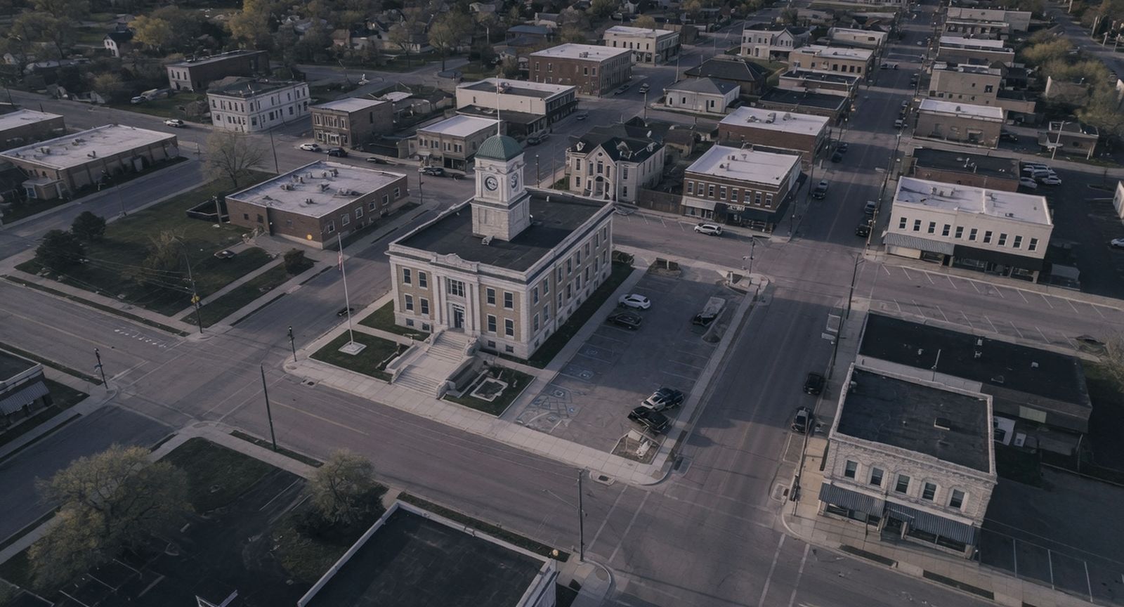 An American city hall and its downtown street grid from the air at dusk